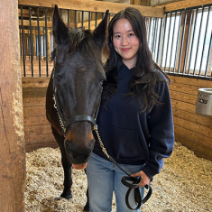 Daphne Lau with a horse.